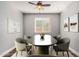 Bright dining room featuring an oval table, stylish chairs, modern art, and natural light at 36076 N Vidlak Dr, San Tan Valley, AZ 85143