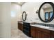 Elegant bathroom featuring dual sinks, granite countertops, and decorative oval mirrors at 36430 N 34Th Ave, Phoenix, AZ 85086