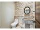 Elegant powder room with stone accent wall, custom vessel sink, and modern fixtures at 36430 N 34Th Ave, Phoenix, AZ 85086