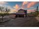 Beautiful two-story home featuring a three-car garage and desert landscaping at sunset at 36430 N 34Th Ave, Phoenix, AZ 85086