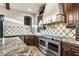 Modern kitchen with stainless steel appliances, granite countertops, and diamond tiled backsplash at 36430 N 34Th Ave, Phoenix, AZ 85086