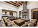 Grand living room with dark wood floors, stone fireplace, and open layout to the gourmet kitchen at 36430 N 34Th Ave, Phoenix, AZ 85086