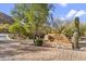 Inviting entrance to The Village at Surrey Hills with lush landscaping and desert scenery at 36600 N Cave Creek Rd # D11, Cave Creek, AZ 85331