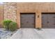 Double car garage showcasing stone facade, and neutral colored stucco, complemented by a paved driveway at 36600 N Cave Creek Rd # D11, Cave Creek, AZ 85331