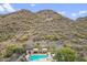 Aerial view of the community pool and spa with a view of the surrounding desert mountains at 36600 N Cave Creek Rd # D11, Cave Creek, AZ 85331