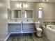 Spa-like bathroom featuring dual sinks, a soaking tub, and modern finishes at 3707 W Carter Rd, Phoenix, AZ 85041