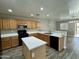 Spacious kitchen with stainless steel appliances, a center island, and ample counter space at 3707 W Carter Rd, Phoenix, AZ 85041