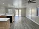 Bright living room featuring tile flooring, modern light fixture, and sliding glass doors at 3707 W Carter Rd, Phoenix, AZ 85041