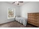 Bright bedroom featuring neutral tones, plush carpeting, and a large window at 3819 E Jasper Dr, Gilbert, AZ 85296