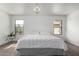 Cozy bedroom featuring a large bed, neutral colors, and two windows with natural light at 3819 E Jasper Dr, Gilbert, AZ 85296