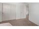 Bright bedroom featuring plush carpeting, a closet with sliding doors, and white walls at 3819 E Jasper Dr, Gilbert, AZ 85296