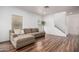 Cozy living room with a large sectional sofa, contemporary flooring, and lots of natural light at 3819 E Jasper Dr, Gilbert, AZ 85296