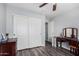 Bedroom with wood-look floors, neutral walls, closet, and vanity at 38226 N Kyle St, San Tan Valley, AZ 85140