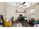 A versatile bedroom with wood floors, a ceiling fan, and natural light at 38226 N Kyle St, San Tan Valley, AZ 85140