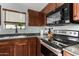 This kitchen features warm wood cabinets, granite countertops, and modern appliances at 38226 N Kyle St, San Tan Valley, AZ 85140