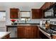 Modern kitchen with stainless steel appliances, granite countertops, and rich wood cabinetry at 38226 N Kyle St, San Tan Valley, AZ 85140