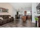 Comfortable living room with open layout and hardwood flooring leading to kitchen and dining at 38226 N Kyle St, San Tan Valley, AZ 85140