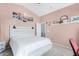 A light pink main bedroom with ocean art, a vaulted ceiling, and a white bed at 38226 N Kyle St, San Tan Valley, AZ 85140