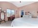 This main bedroom has pink walls, lots of natural light, and a vaulted ceiling at 38226 N Kyle St, San Tan Valley, AZ 85140