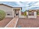 Backyard view featuring a paved walkway leading to a gated patio area at 3921 E Runaway Bay Pl, Chandler, AZ 85249