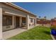 Relaxing covered patio with comfortable seating and lush artificial grass at 3921 E Runaway Bay Pl, Chandler, AZ 85249