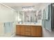 Bathroom featuring a double sink vanity, spacious shower, and modern lighting fixtures at 3921 E Runaway Bay Pl, Chandler, AZ 85249