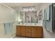 Bathroom featuring double vanity sinks, soft lighting and a glass shower door at 3921 E Runaway Bay Pl, Chandler, AZ 85249