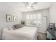 Bright bedroom showcasing a ceiling fan, window shutters, and serene decor at 3921 E Runaway Bay Pl, Chandler, AZ 85249