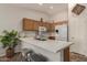 Modern kitchen featuring an island with white countertops, oak cabinets, and stainless steel appliances at 3921 E Runaway Bay Pl, Chandler, AZ 85249