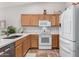 Kitchen featuring stove, microwave, modern sink, and ample storage at 3921 E Runaway Bay Pl, Chandler, AZ 85249