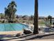 Well-maintained swimming pool area with chairs, landscaping, and mountain views at 3921 E Runaway Bay Pl, Chandler, AZ 85249