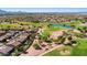 Aerial view of a golf course community with homes, a pond, and green fairways at 4138 E Indigo St, Gilbert, AZ 85298