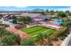 Aerial view of a bocce ball court, a pool, and clubhouse, with well-manicured landscaping at 4138 E Indigo St, Gilbert, AZ 85298