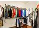 Walk-in closet featuring organized clothing racks, shoe shelves, and wood flooring at 4138 E Indigo St, Gilbert, AZ 85298