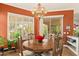 Stylish dining area featuring wood table, elegant chandelier, and sliding glass doors to the patio at 4138 E Indigo St, Gilbert, AZ 85298