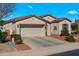 Single-story home featuring a two-car garage, red tile roof, and desert landscaping at 4138 E Indigo St, Gilbert, AZ 85298