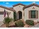 Inviting front entrance featuring an arched entryway, desert landscaping, and a charming architectural design at 4138 E Indigo St, Gilbert, AZ 85298