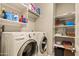 Laundry room featuring a washer, dryer, and shelving for storage and organization at 4138 E Indigo St, Gilbert, AZ 85298