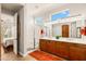 Bright bathroom offers dual sinks, a walk-in shower, and a view into the main bedroom at 4138 E Indigo St, Gilbert, AZ 85298