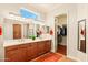 Bathroom featuring dual sinks, a spacious walk-in closet, and a bright window at 4138 E Indigo St, Gilbert, AZ 85298