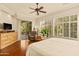 Bright main bedroom with plantation shutters, ceiling fan, and a sliding door for easy access to outdoor at 4138 E Indigo St, Gilbert, AZ 85298