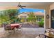 Relaxing covered patio with table and chairs offers a serene outdoor living space and landscaped views at 4138 E Indigo St, Gilbert, AZ 85298