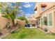 Beautiful backyard with lush grass, desert landscaping, and a peaceful ambiance at 4151 E Mercer Ln, Phoenix, AZ 85028