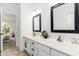 Bathroom featuring dual sinks, framed mirrors, and a view of the bedroom at 4151 E Mercer Ln, Phoenix, AZ 85028