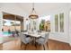 Bright dining room with stylish lighting, seating, and outdoor views at 4151 E Mercer Ln, Phoenix, AZ 85028