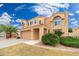 Two-story stucco house with a tile roof, desert landscaping, and a two car garage at 4151 E Mercer Ln, Phoenix, AZ 85028