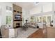 Bright living room featuring a stone fireplace, large windows with shutters, and hardwood floors at 4151 E Mercer Ln, Phoenix, AZ 85028