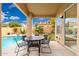 Outdoor patio with seating area overlooking a private swimming pool and landscaped yard at 4151 E Mercer Ln, Phoenix, AZ 85028