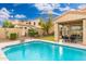 Sparkling pool with patio seating and a well-manicured backyard at 4151 E Mercer Ln, Phoenix, AZ 85028