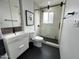 Stylish bathroom with modern vanity, glass shower, black hardware and black hexagon tile floor at 4206 N 38Th St # 3, Phoenix, AZ 85018